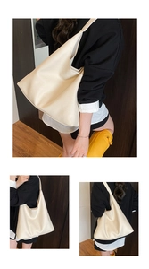 Detail shot of a cream-colored large hobo tote bag featuring premium lychee texture leather