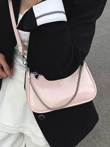 Pink faux leather half-moon baguette bag with silver chain strap and heart charm zipper