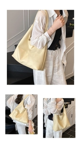 Detail of large beige leather tote bag featuring a textured lychee grain and soft drape
