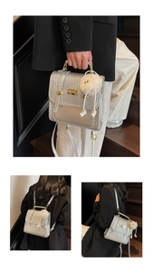 Close-up of silver quilted texture handbag with plush charm and versatile straps