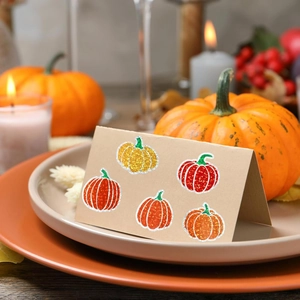 Sparkly pumpkin stickers for fall decorations and Thanksgiving envelope seals on brown card