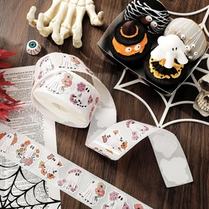 Detail of cute Halloween ghost stickers with floral accents on a wooden background