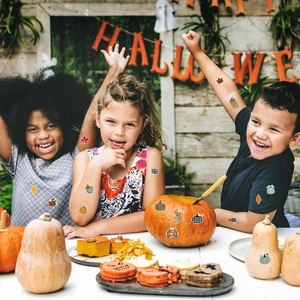 Waterproof vinyl pumpkin and maple leaf temporary tattoos for kids at a Halloween party