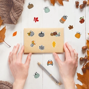Waterproof vinyl autumn stickers featuring pumpkins and maple leaves on a wooden table