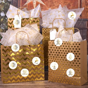 Détail de sacs cadeaux de Noël avec motifs chevron dorés et étiquettes autocollantes