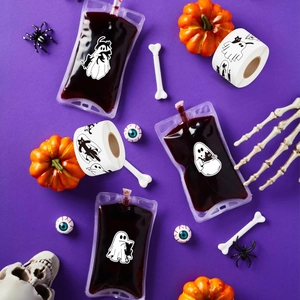 Halloween drink pouches with ghost cat stickers set on a purple festive themed background