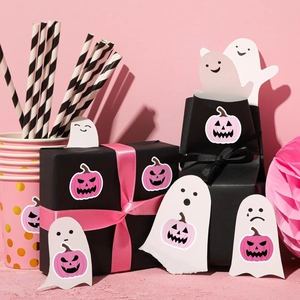 Pink pumpkin and ghost stickers on a black gift box for Halloween party decoration