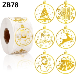 Macro view of gold foil Christmas stickers featuring snowflakes and reindeer patterns