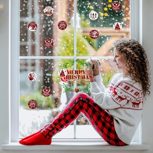 Girl at window showing various Christmas static stickers with Santa and snowman patterns