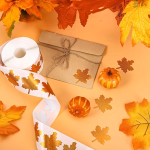Detail of holographic maple leaf stickers on a roll for Thanksgiving gift wrapping