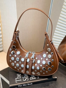 Brown leather hobo bucket bag with silver studs and a metallic dual zipper closure