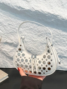 White hobo bucket bag with silver studs and dual zipper closure for a stylish summer look