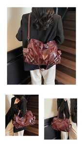 Detail of burgundy vintage tote bag with glossy leather texture and metal buckles