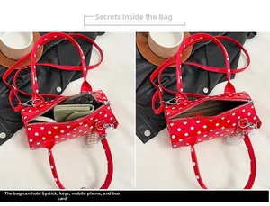 Internal view of red polka dot barrel bag showing capacity for phone and wallet