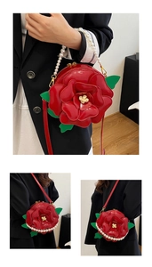 Detail of red 3D rose crossbody bag featuring pearl handle and detachable shoulder strap