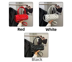 Polka dot cylinder handbags in red, white, and black with detachable shoulder straps