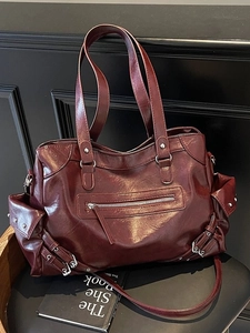 Vintage burgundy rivet tote bag with large capacity and multi-pocket design on chair