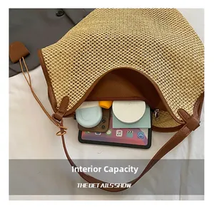 Detail view of large straw bucket bag interior showing capacity for tablet and daily items
