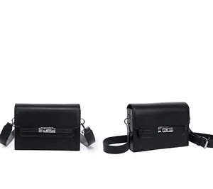 Detail view of a black leather Kelly bag featuring a silver rectangular twist lock closure