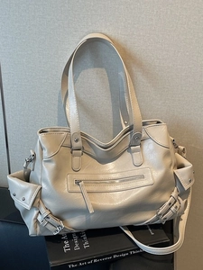 Chic beige rivet motorcycle tote bag with multi-pocket design for stylish urban commuting