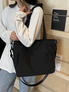 Black large capacity nylon tote bag with multiple zip pockets and adjustable strap