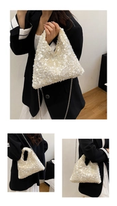 Close-up of pearl sequins finish and silver chain strap on white fashion handbag