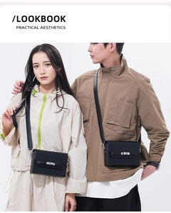 Minimalist black leather box bag with silver twist lock shown in a couple lookbook shot