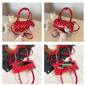 Detailed interior of red polka dot cylinder bag showing daily essentials capacity