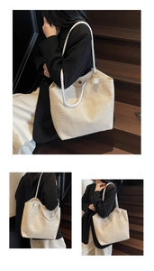 Detail of large woven straw tote bag with rope handles for beach and travel