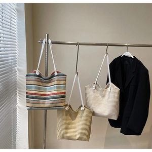 Large woven straw beach tote bag with colorful stripes and white rope handles