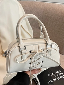 Minimalist beige crossbody shoulder bag with lace-up bow detail and silver hardware