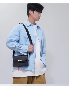 Men's minimalist black leather crossbody bag worn by a male model for fashion look