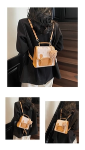 Detailed view of mini backpack featuring brown leather patchwork and bear keychain