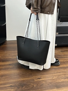 Minimalist large black matte leather tote bag with stylish metal chain handles