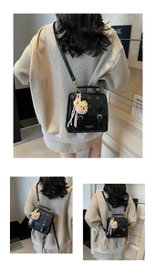 Detailed view of the mini black backpack with vintage pattern and cute bear keychain charm
