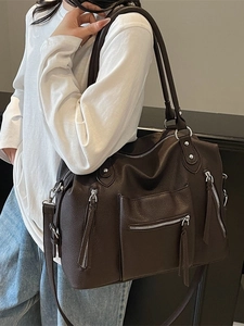 Large dark brown vintage tote bag in soft leather with multiple pockets and tassels