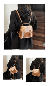 Detail of vintage canvas backpack with elk pattern, leather trim and bear charm