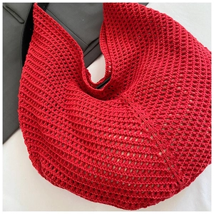 Detailed close-up showing the red hand-woven hollow crochet texture of the large tote bag