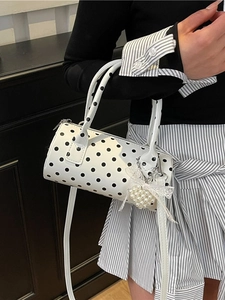 Chic white polka dot cylinder handbag with pearl heart charm and adjustable strap