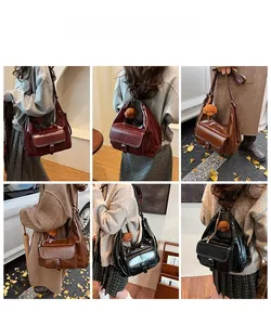 Fashionable faux leather shoulder bag in multiple colors with a cute plush bear pendant