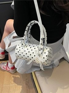 Chic white barrel bag with black polka dots featuring lace bow and pearl charm strap