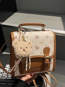 Women's cream printed mini backpack with brown leather trim and cute bear charm