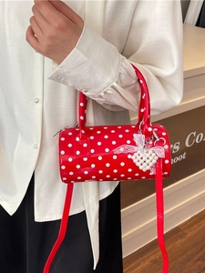 Red polka dot cylindrical handbag with a heart pearl charm and detachable shoulder strap