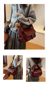 Deep red vintage faux leather crossbody bag with teddy bear pendant shown on shoulder