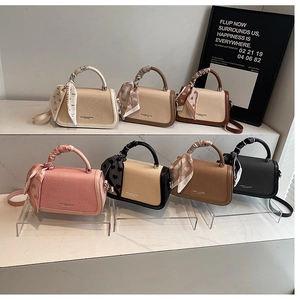 Collection of mini leather handbags in various colors with decorative silk heart scarves