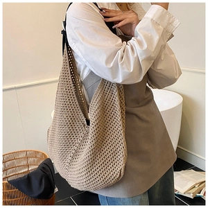 Close-up of beige crochet shoulder bag with intricate woven hollow-out mesh texture