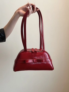 Glossy red patent leather bowling bag with bow detail and dual long handles