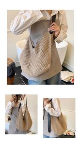 Detail of hollow woven tote bag with a contrast black wide shoulder strap and knit texture