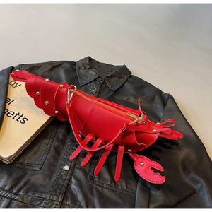 Detail of red lobster-shaped crossbody bag with gold metal zipper and PU leather texture