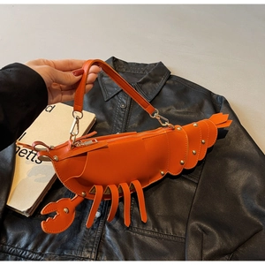 Macro shot of lobster bag's bright orange PU leather texture and rivet details